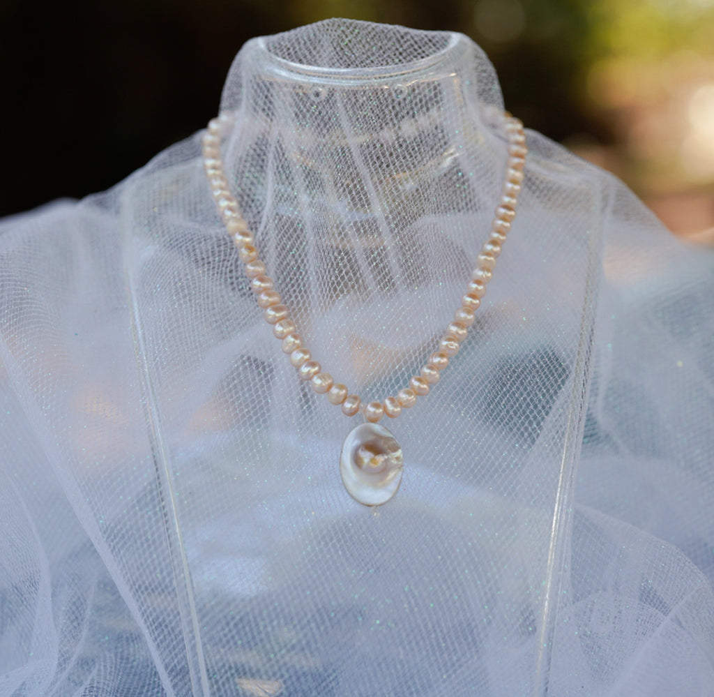 Arwen’s Pearl “Locket” necklace made with mother of pearl.