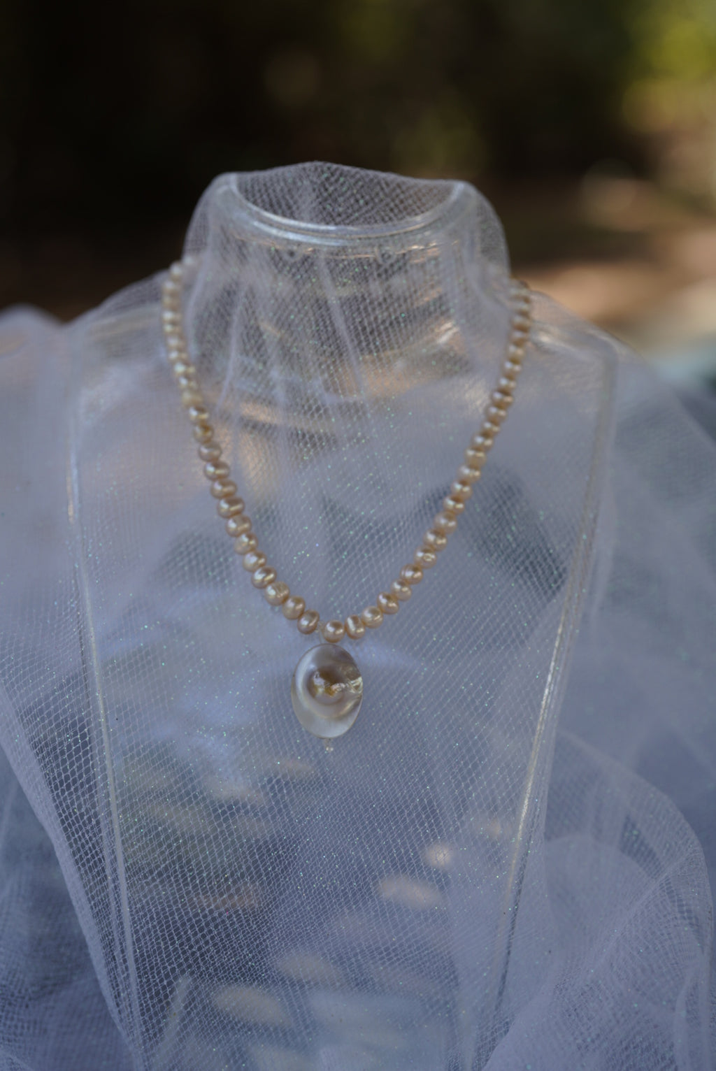 Arwen’s Pearl “Locket” necklace made with mother of pearl.