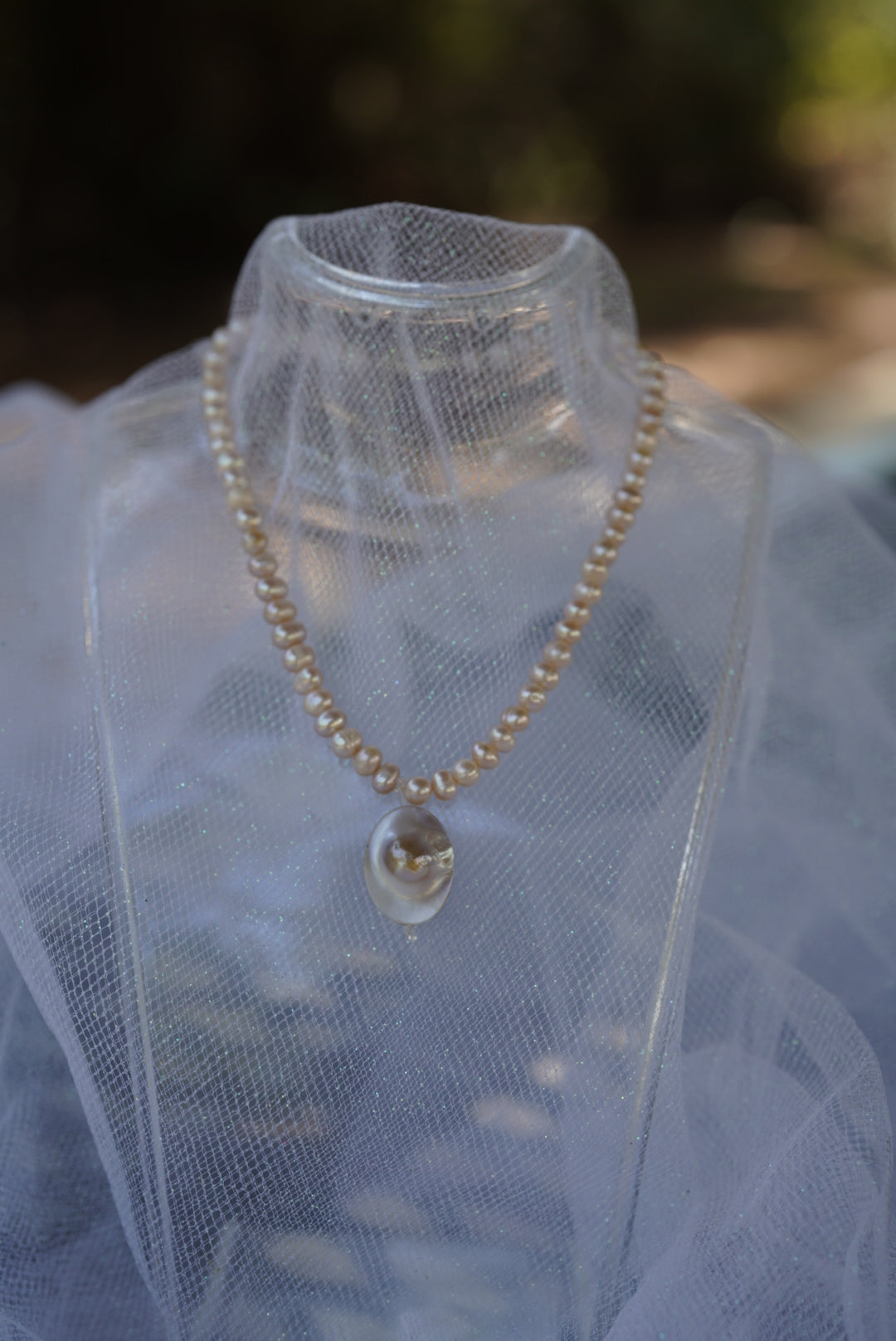 Arwen’s Pearl “Locket” necklace made with mother of pearl.