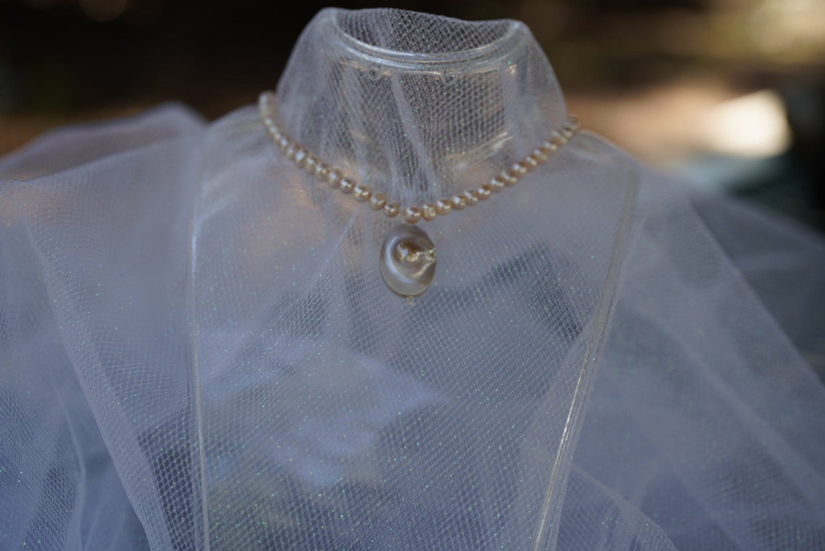 Arwen’s Pearl “Locket” necklace made with mother of pearl.