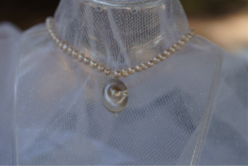 Arwen’s Pearl “Locket” necklace made with mother of pearl.